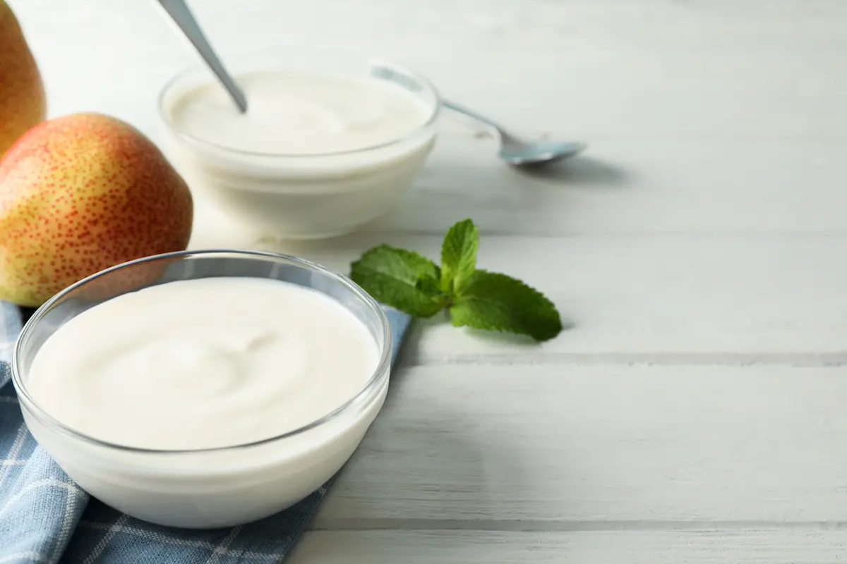 composition with cream yogurts and fruits on white 2023 11 27 05 05 18 utc